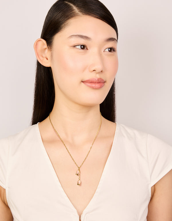 Beautifully crafted waterproof gold plated stainless steel pink tulips pendant necklace with floral in dainty style on model view