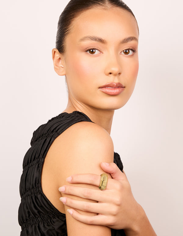 Featuring a waterproof geometric square ring in gold plated stainless steel with statement design on finger view