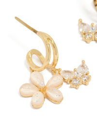 Featuring gold cubic zirconia butterfly and flower double hoop earrings with floral charms close up view - link has visual effect only