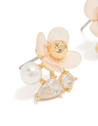 Beautifully crafted gold plated cubic zirconia and pink acrylic flower stud earrings featuring pear cut crystal and pearl in white close up view - link has visual effect only