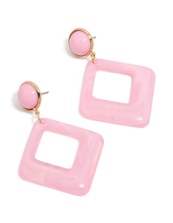 Showcasing statement drop earrings in gold and pink with acrylic diamond shaped design front view