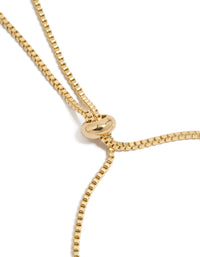 Highlighting a gold plated bracelet with cubic zirconia flower and pearl rondell charm accents in toggle design closure detail view - link has visual effect only