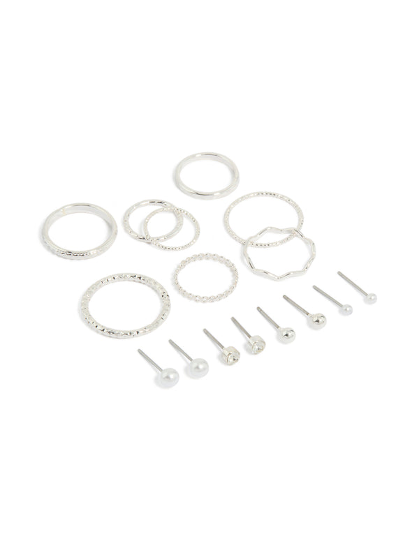 Showcasing dainty stud earrings featuring pearl and ball designs, along with rings in a 12-piece set with a silver finish front view
