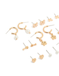 Explore this dainty stud earrings 12-pack featuring bow charm cross floral, balls and heart designs enamel crafted in gold with pearl accents white and pink details close up view - link has visual effect only