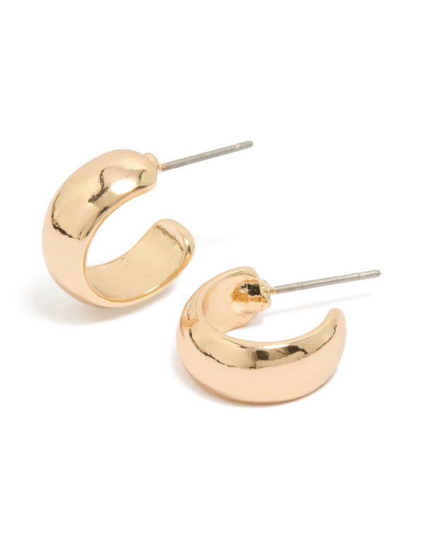 Showcasing small basic open huggie earrings in gold with huggie closure front view