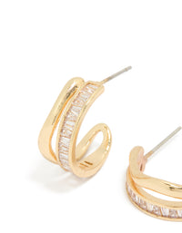 Highlighting statement style hoop earrings with baguette cut stones in gold plated wave layered design close up view - link has visual effect only