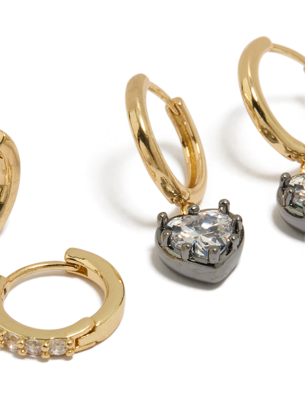 Crafted from mixed metal plated heart and cubic zirconia huggie earrings in a 2-pack, gold and silver tones, and huggie closure close up view