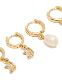 Featuring pearl huggie hoop 2-pack earrings crafted from gold plated cubic zirconia and crystal in ivory close up view - link has visual effect only