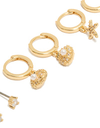 Crafted from gold plated materials, cubic zirconia studs and mini starfish huggie earrings 3-pack with shell, ocean pearl crystal close up view - link has visual effect only
