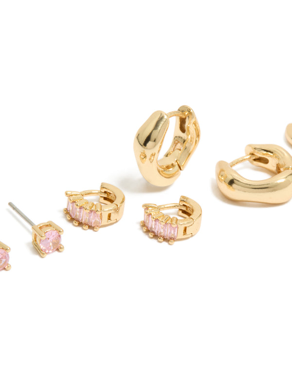 Showcasing gold plated pink cubic zirconia stud and huggie earrings in a 4-pack with chunky style descriptor, baguette stone cut close up view