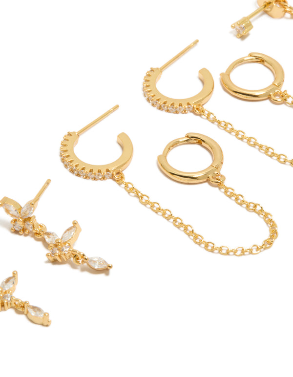 Highlighting gold plated butterfly and chain earrings in a 4-pack, cubic zirconia stones, crystal embellishments, and huggie closures close up view