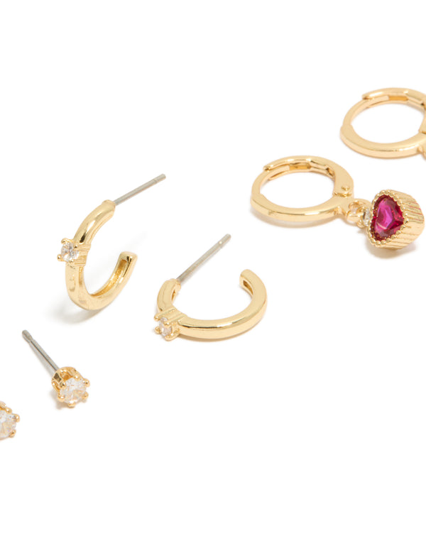 Explore gold plated cubic zirconia studs and heart huggie earrings with charm featuring crystal closure hoop in a 3-pack set close up view
