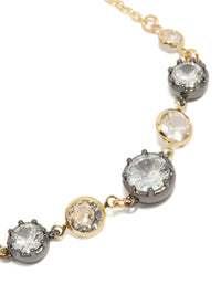 Showcasing a mixed metal plated toggle bracelet with cubic zirconia and crystal accents in gold, silver, and clear close up view - link has visual effect only