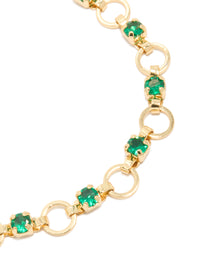 Explore the intricate details of this gold plated link bracelet with alternating round green cubic zirconia close up view - link has visual effect only