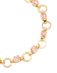 Showcasing gold plated statement bracelet with alternating pink cubic zirconia round stone cut links close up view - link has visual effect only