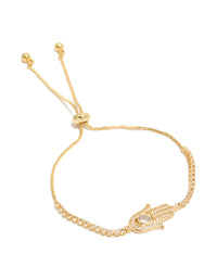 Crafted from gold plated material, this bracelet features a hamsa hand with cubic zirconia stones in a statement style front view - link has visual effect only