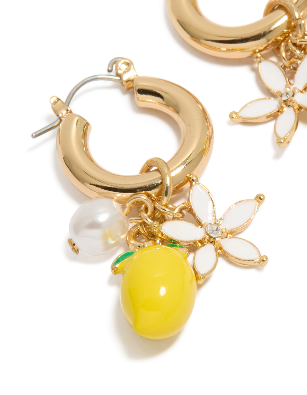 Highlighting gold charm huggie earrings with floral accents, fruit design lemon, pearl details, and yellow color in a close up view