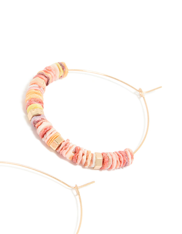 Displaying large hoop earrings with beaded genuine pink shells and statement style in gold post detail view