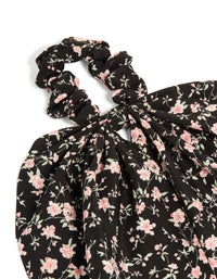 Featuring floral printed fabric in black and pink, this statement scarf scrunchie is shown in side view - link has visual effect only