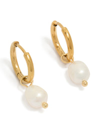 Featuring waterproof gold plated stainless steel freshwater pearl huggie earrings in ivory front view - link has visual effect only
