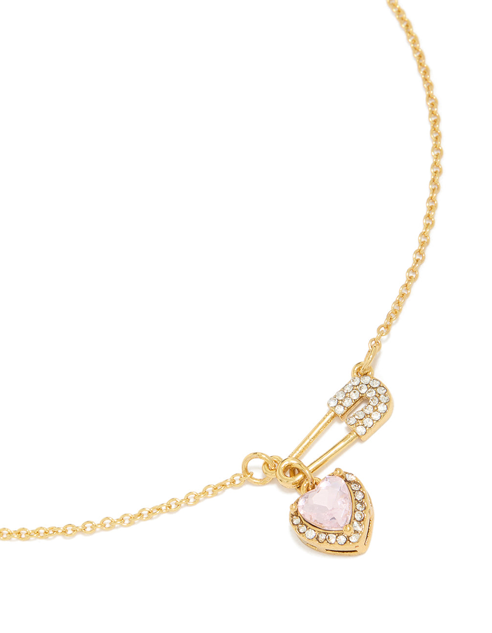 Showcasing a tweens diamante safety pin necklace with heart charm crafted from gold plated stainless steel in waterproof statement style close up view