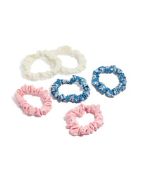 Showcasing a set of six tweens scrunchies featuring floral print in light pink sky blue ivory and white front view - link has visual effect only