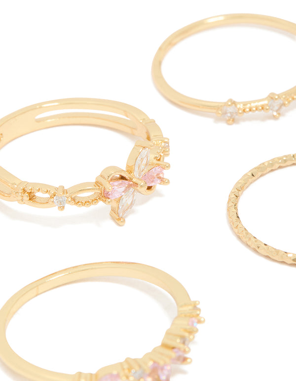 Featuring gold pink and clear cubic zirconia flower rings 5-pack with butterfly charm and floral crystal details close up view