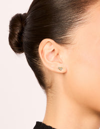 Crafted from gold plated surgical steel, these oval and circle cubic cluster zirconia flat back studs feature clear stones, shown on ear view - link has visual effect only