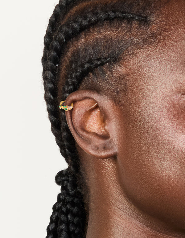 Showcasing a gold plated surgical steel cubic zirconia flower and leaves clicker ring on ear view