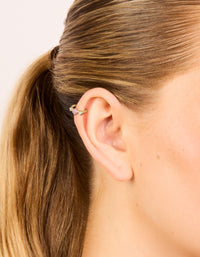 Showcasing gold plated surgical steel multi cubic zirconia circle clicker ring with crystal accents in pink and aquamarine shades on ear view - link has visual effect only