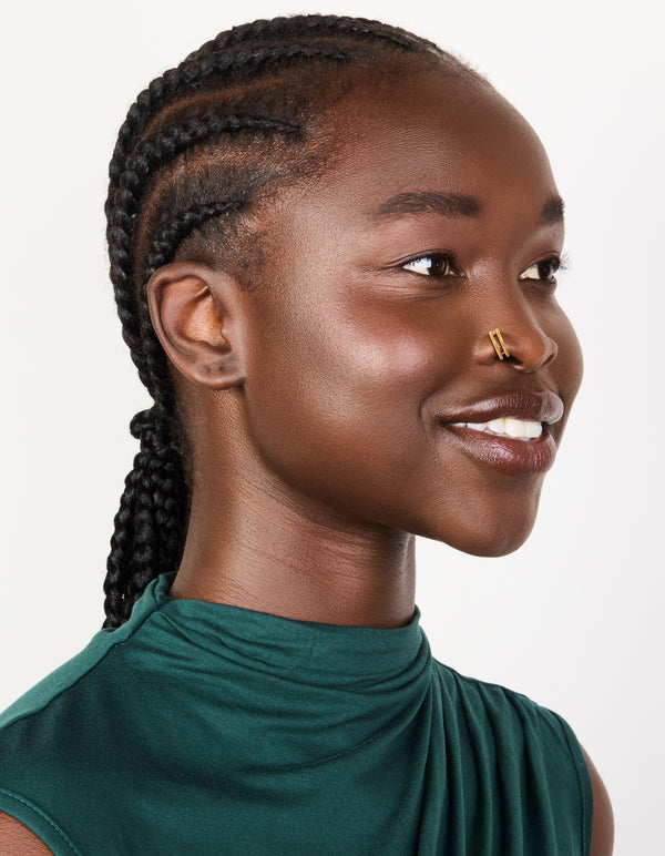 Showcasing gold plated surgical steel double hinged nose rings in a pack nose view