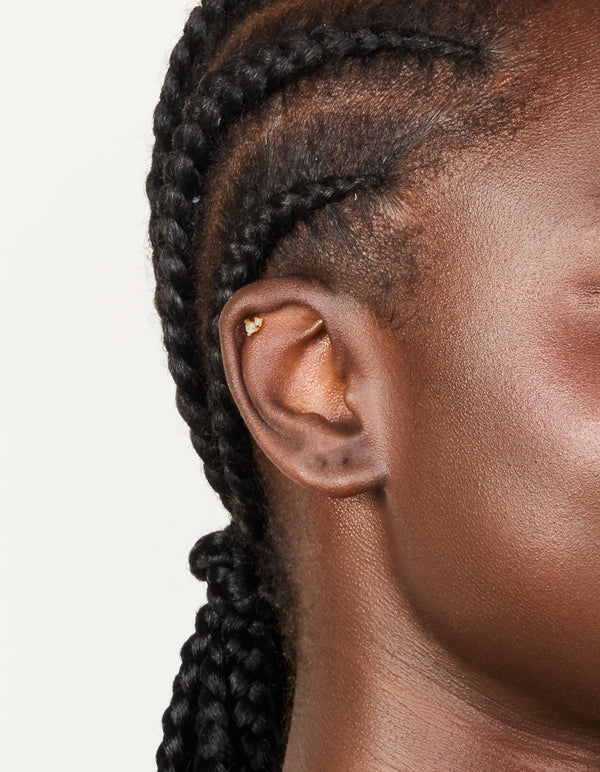 Featuring a gold plated titanium cubic zirconia pear cluster single flat back stud on ear view