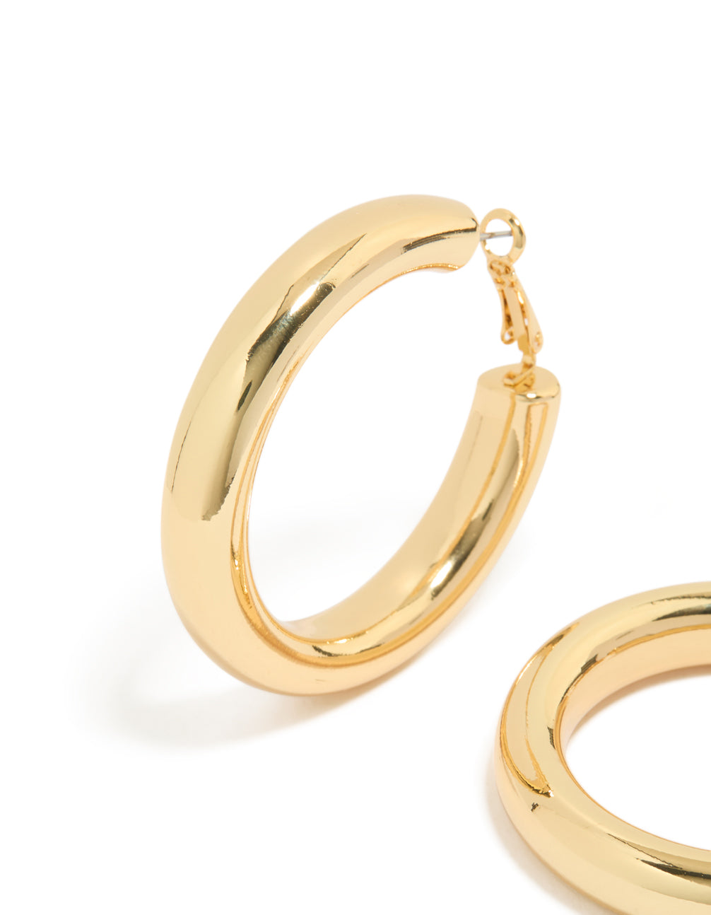 Highlighting statement hoop earrings crafted from gold plated material close up view