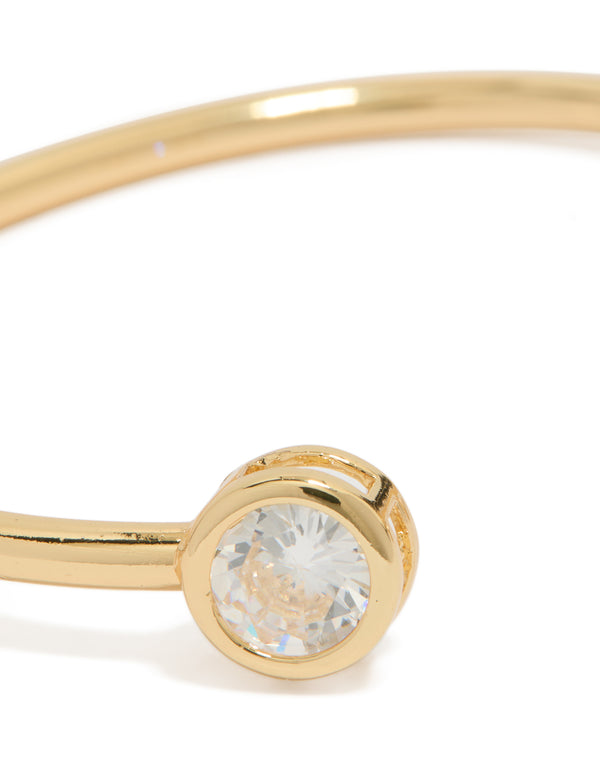 Highlighting a gold plated cubic zirconia open wrist cuff in clear close up view