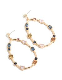 Showcasing statement earrings in an oval stone cut with blue, pink, and clear diamantes set in a gold open drop design front view - link has visual effect only
