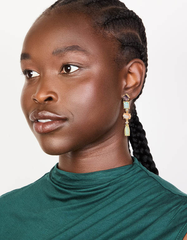 Designed with gold irregular shaped purple and blue diamantes drop earrings in statement style on model view
