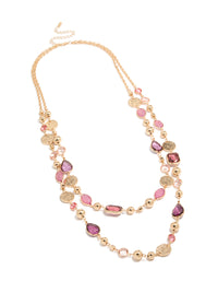 Elegantly designed gold disc and pink beaded layered long necklace with charms details in coral and purple accents in a chunky style front view - link has visual effect only