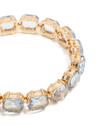 Highlighting a gold large light blue diamantes bracelet close up view - link has visual effect only