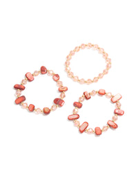 Explore these beaded stretch bracelets featuring shell details in light coral, light pink, and gold tones as a 3-pack front view - link has visual effect only
