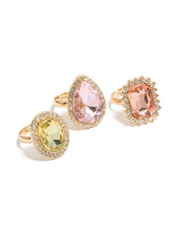 Showcasing gold pink and purple pastel diamante rings in a 3-pack with halo and oval stone cut featuring statement style view - link has visual effect only