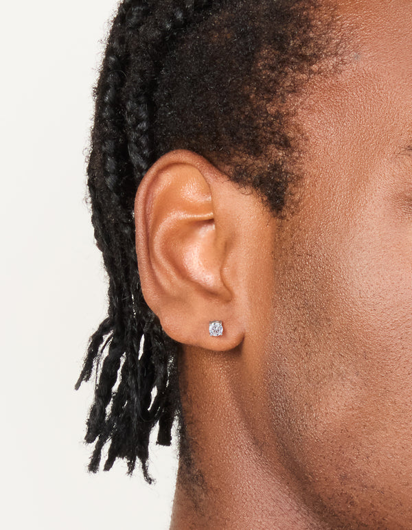 Featuring mens waterproof stainless steel mini round clear cubic zirconia stud earrings in silver on ear view