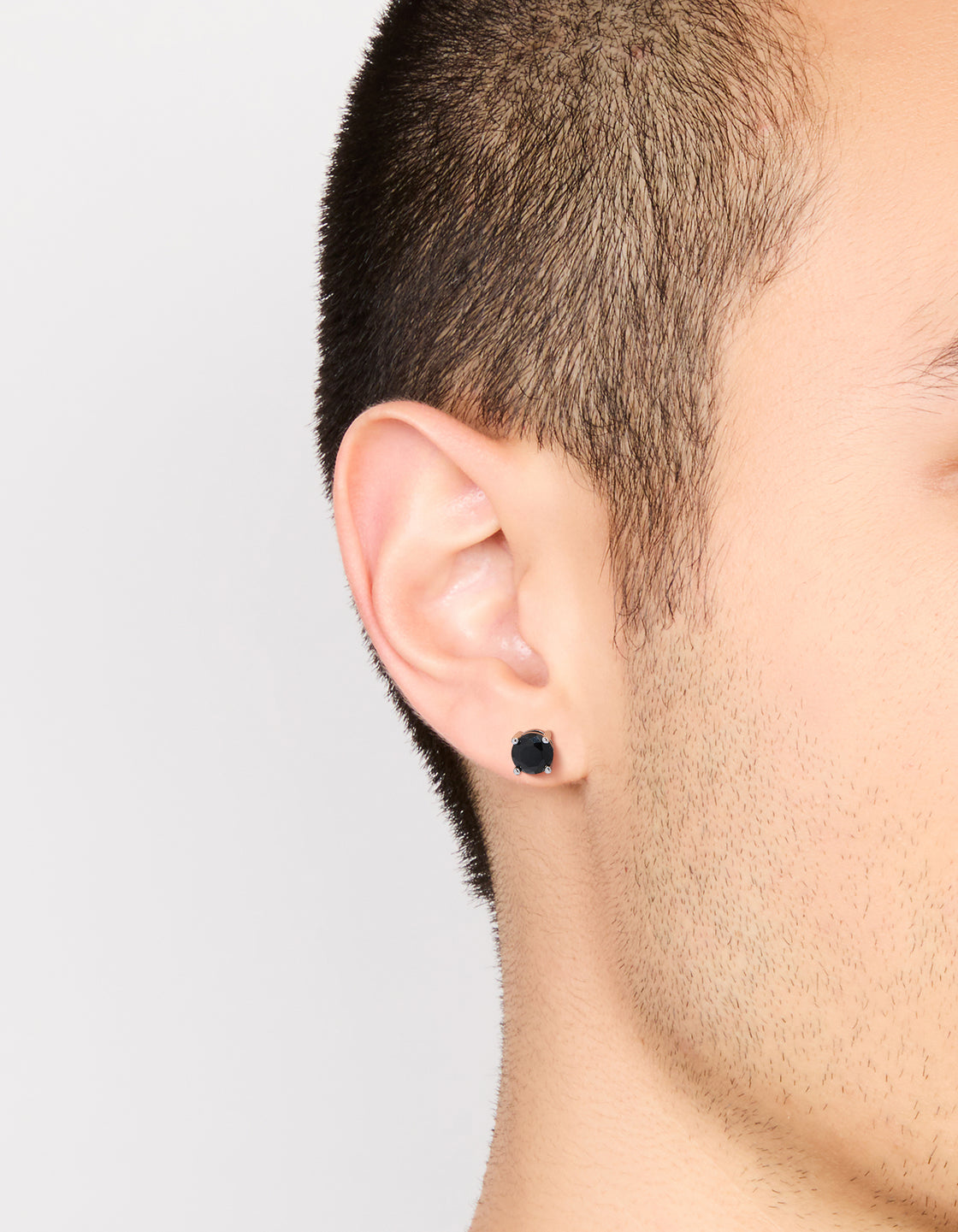 Mens round cut stud earrings with black cubic zirconia in waterproof stainless steel and silver on ear view