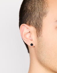 Mens round cut stud earrings with black cubic zirconia in waterproof stainless steel and silver on ear view - link has visual effect only