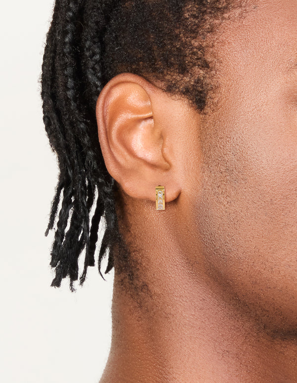 Featuring mens waterproof square cubic zirconia huggie earrings crafted from gold plated stainless steel in an on ear view
