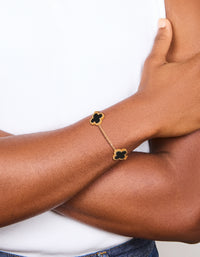 Featuring a waterproof gold plated stainless steel black clover chain bracelet with charm accents in a dainty style on wrist view - link has visual effect only