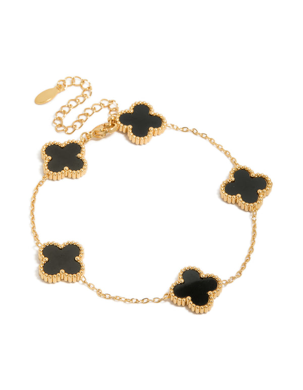 Showcasing a waterproof gold plated stainless steel black clover chain bracelet with charm details in a dainty style front view