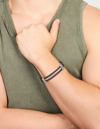Featuring a mens waterproof stainless steel black and silver wire twisted wrist cuff bracelet on wrist view - link has visual effect only