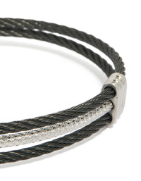 Highlighting a mens waterproof stainless steel black and silver wire twisted wrist cuff bracelet close up view - link has visual effect only