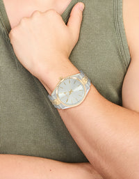 Showcasing a men's mixed metal etched link classic watch with white dial, round shape, formal occasion, link band in multi-color, and analog type on wrist view - link has visual effect only
