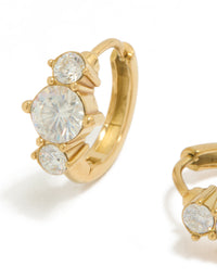 Highlighting dainty trio mini huggie earrings in waterproof gold plated stainless steel with cubic zirconia close up view - link has visual effect only